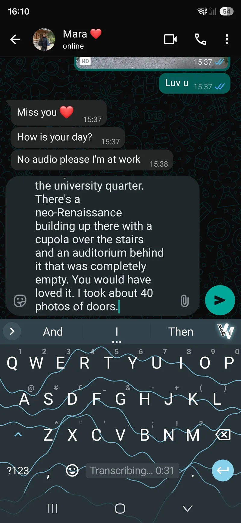 A phone in a chat, several paragraphs of dictated prose already written into the message box, the keyboard below showing a transcription timer running.